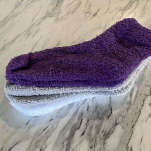 3 pack of fuzzy socks. White, grey, and purple.